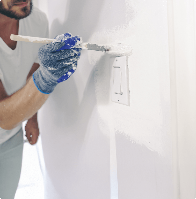 Painter rolling fresh paint onto an interior wall