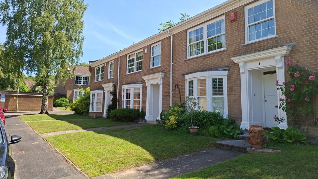 Row of terraced houses following exterior redecoration in Bransgore