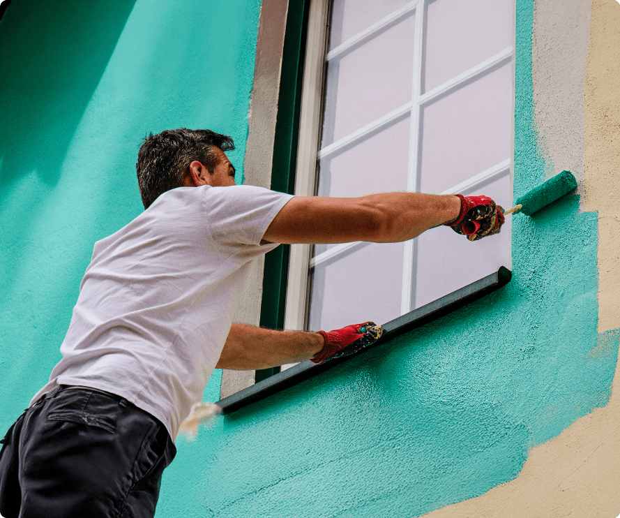 Professional painter and decorator working on an exterior window in Bournemouth